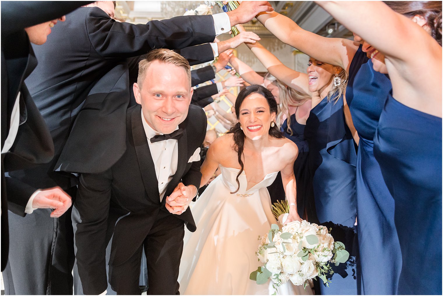 newlyweds walk under arch at Shadowbrook at Shrewbsury