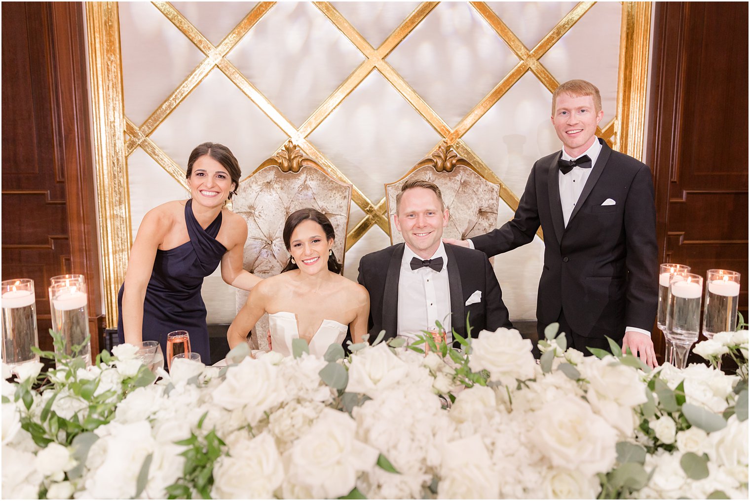 newlyweds pose with best man and maid of honor 