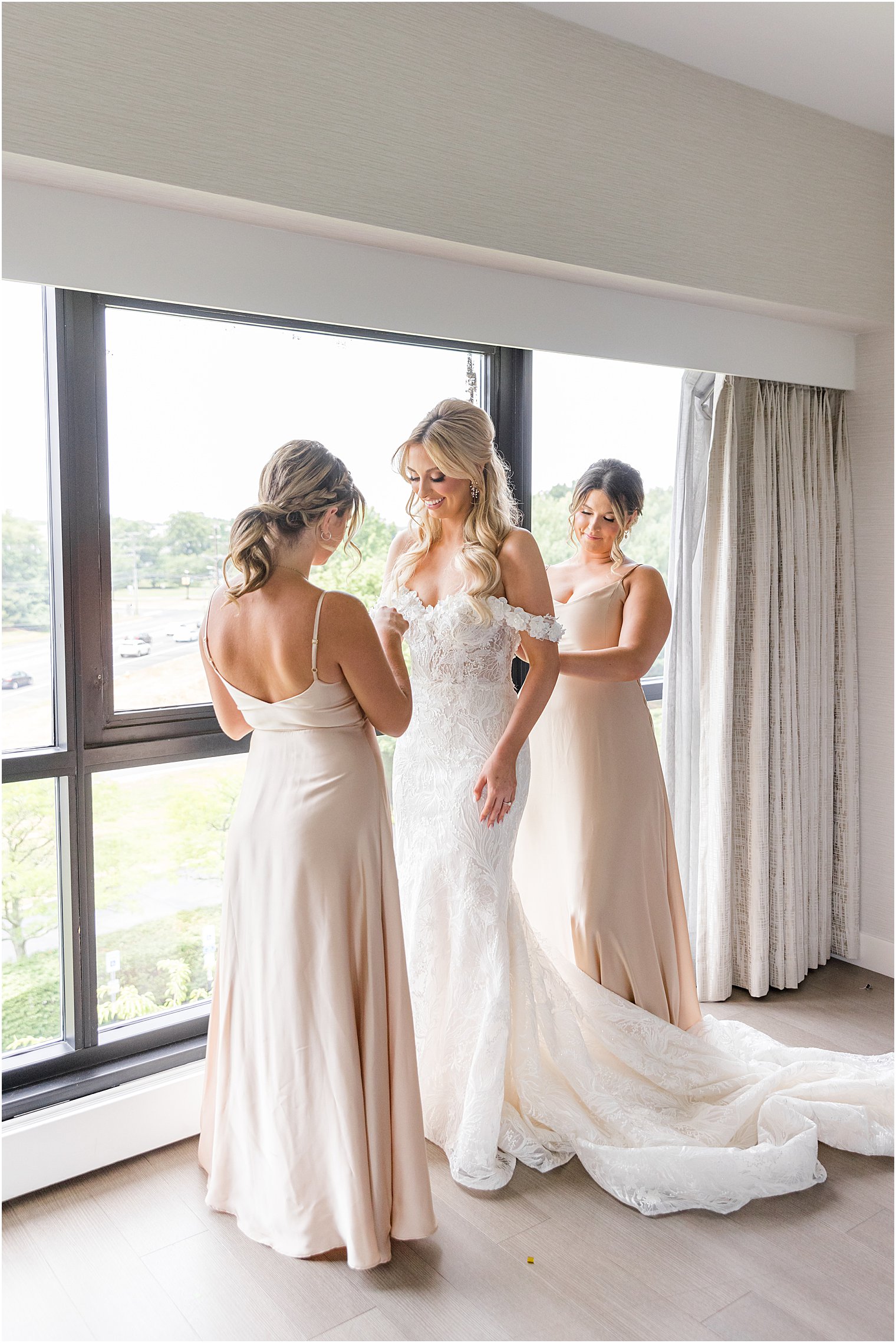 bride gets into wedding dress with family during prep for The English Manor wedding