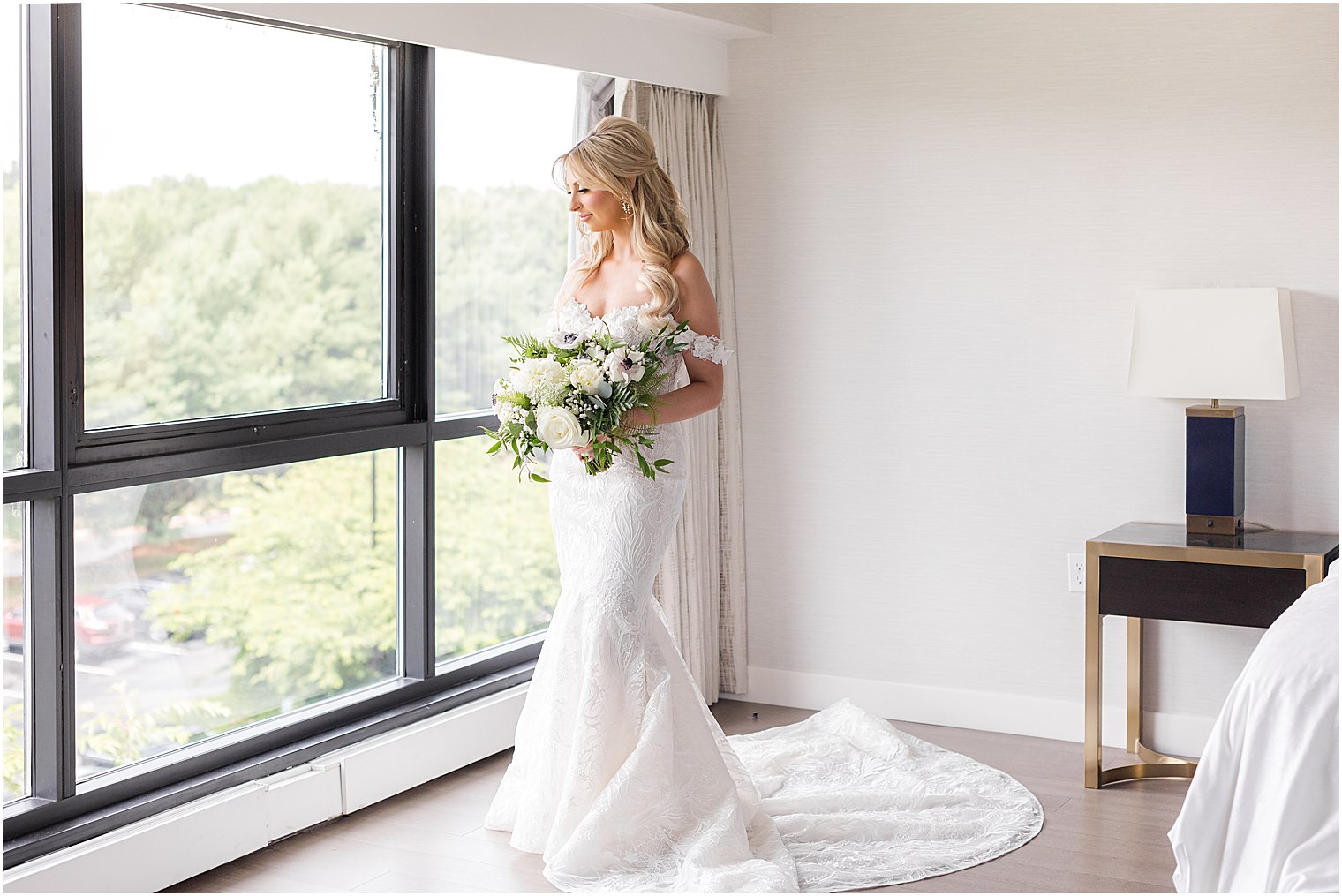 bride stands in front of window at The English Manor
