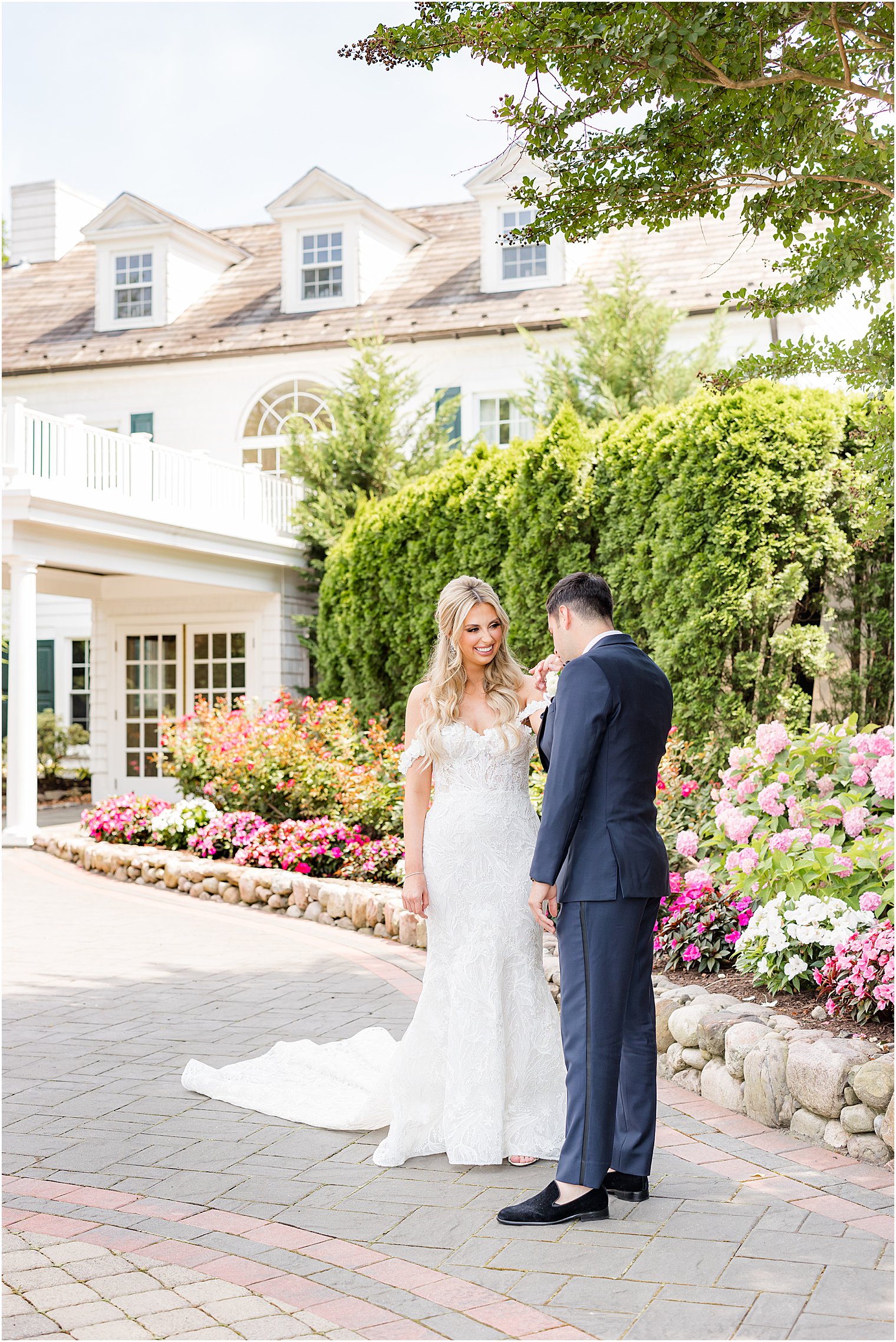 groom looks at bride during first look