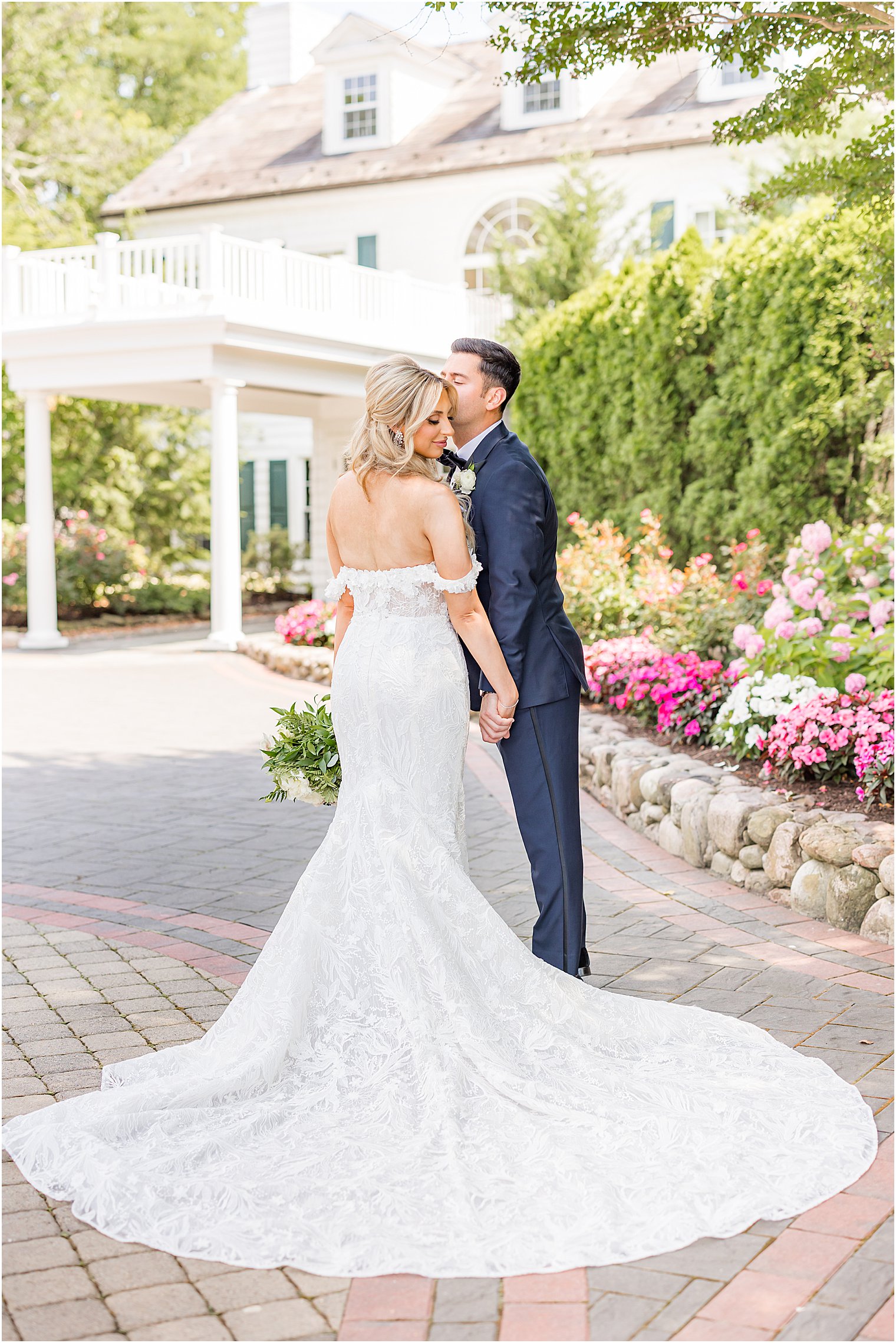 groom kisses bride's forehead during NJ wedding portraits 