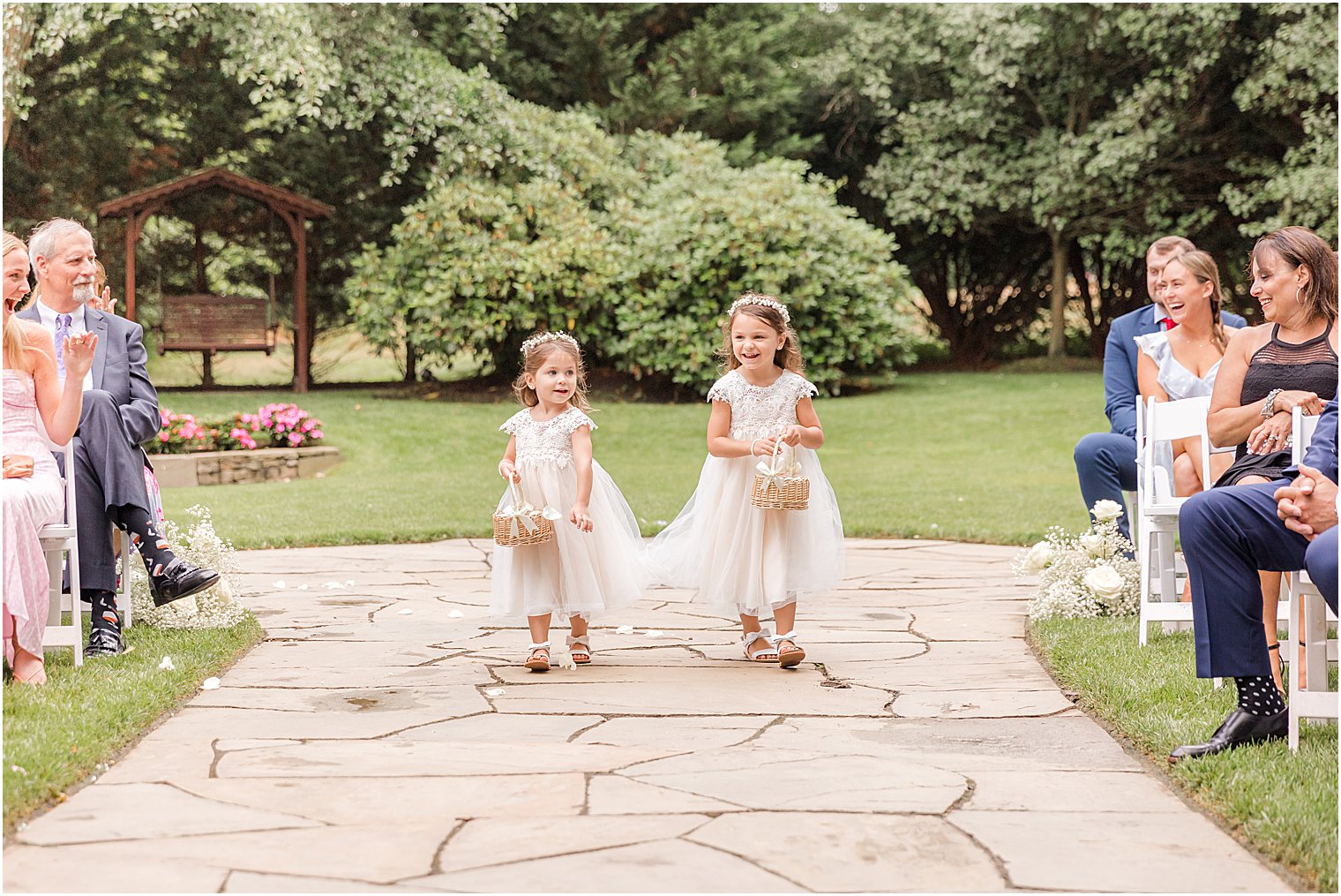 flower girls walk down aisle at The English Manor