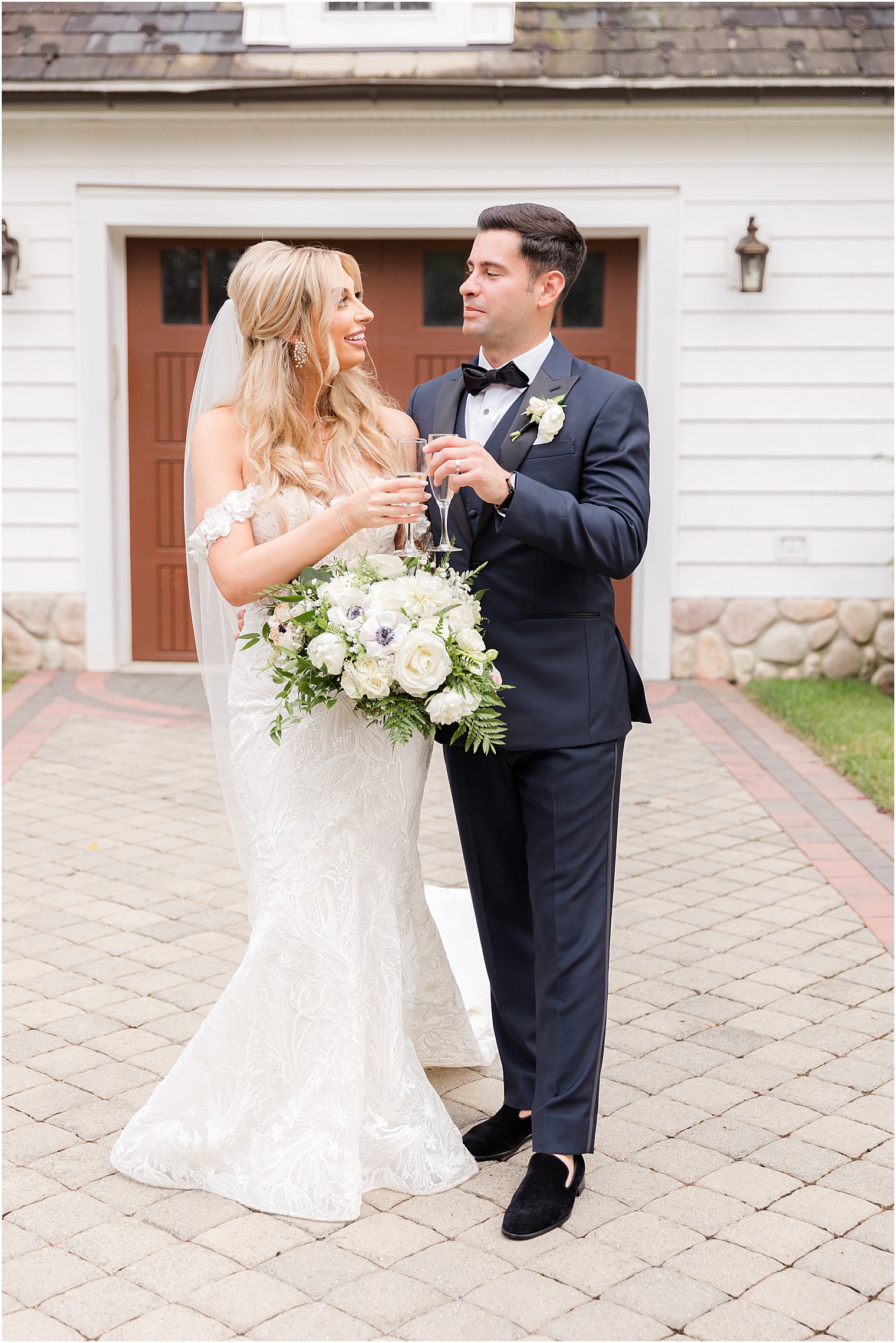 bride and groom smile together outside White House at The English Manor