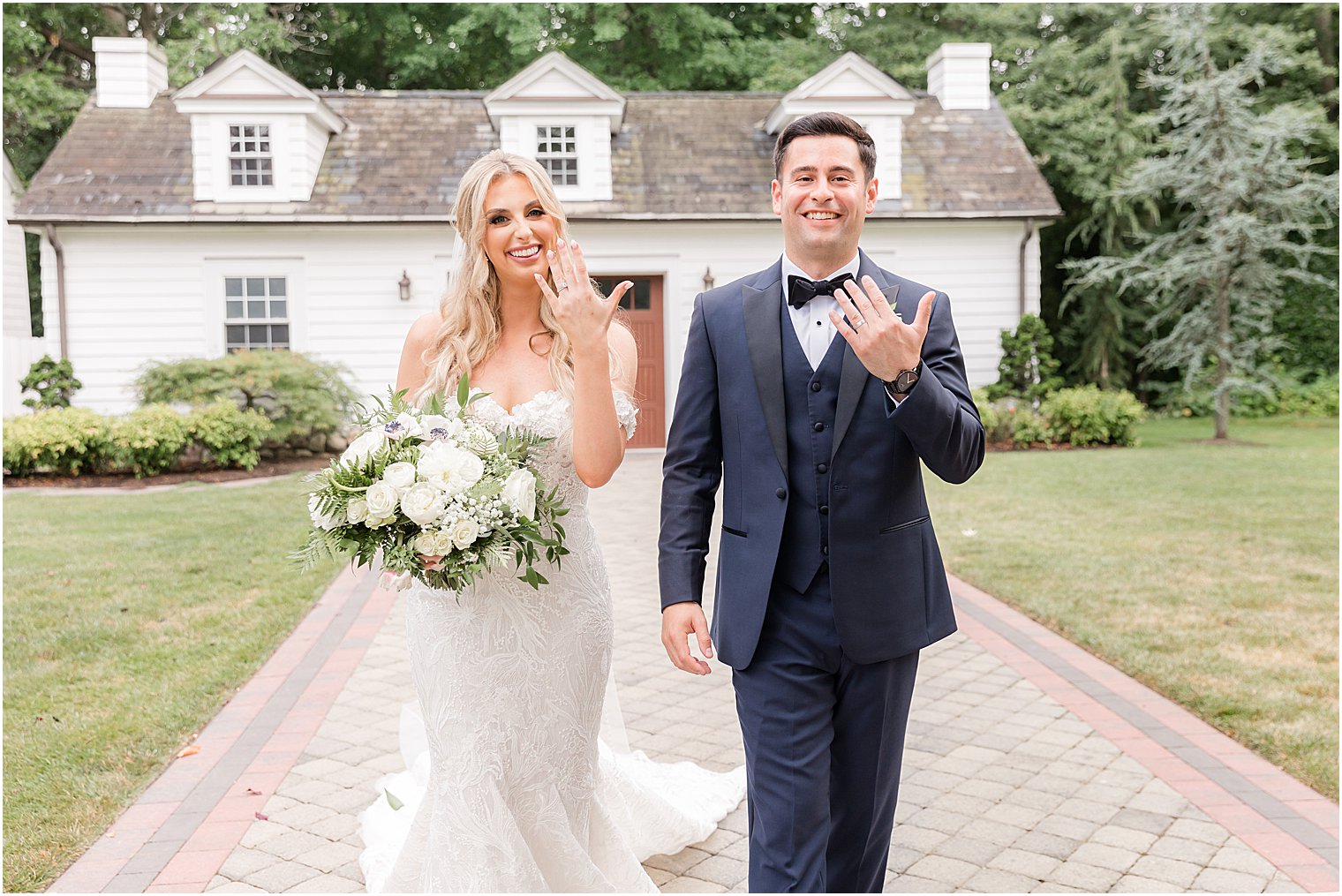 bride and groom walk showing off rings at The English Manor