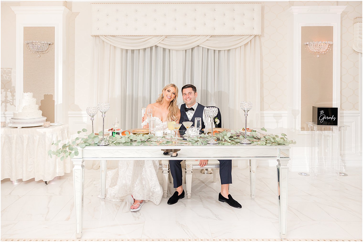 bride and groom sit at sweetheart table at The English Manor