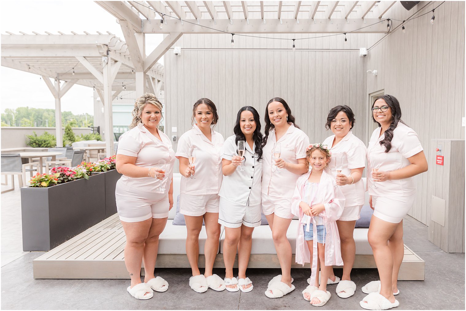 bridesmaids pose on patio in matching pajamas