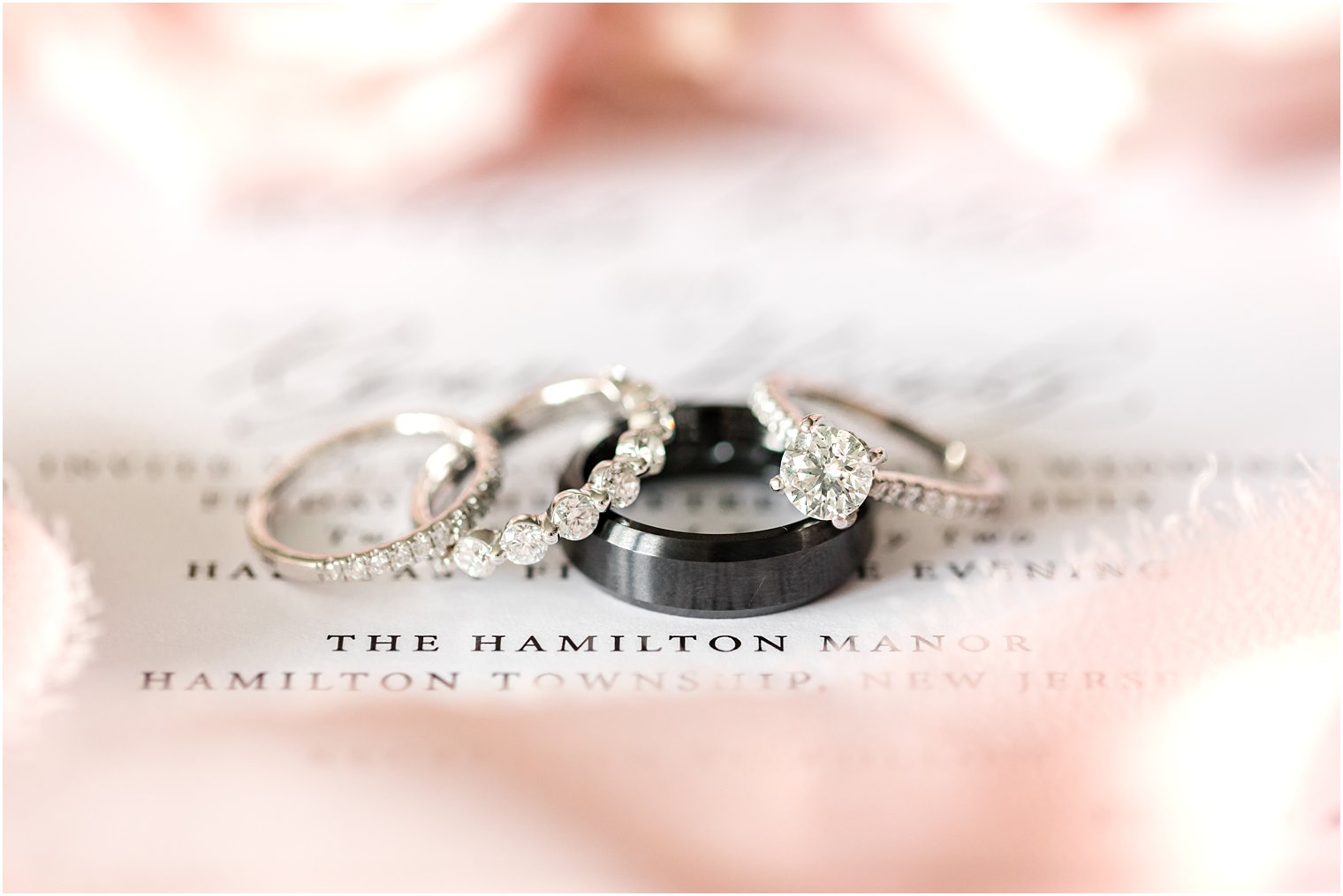 wedding rings rest on invitation suite 