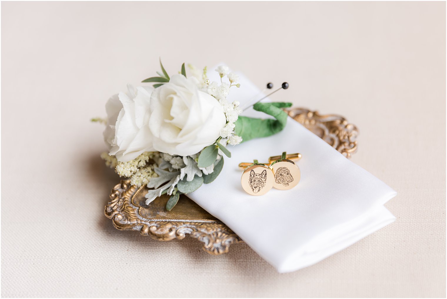 groom's custom cufflinks on gold tray