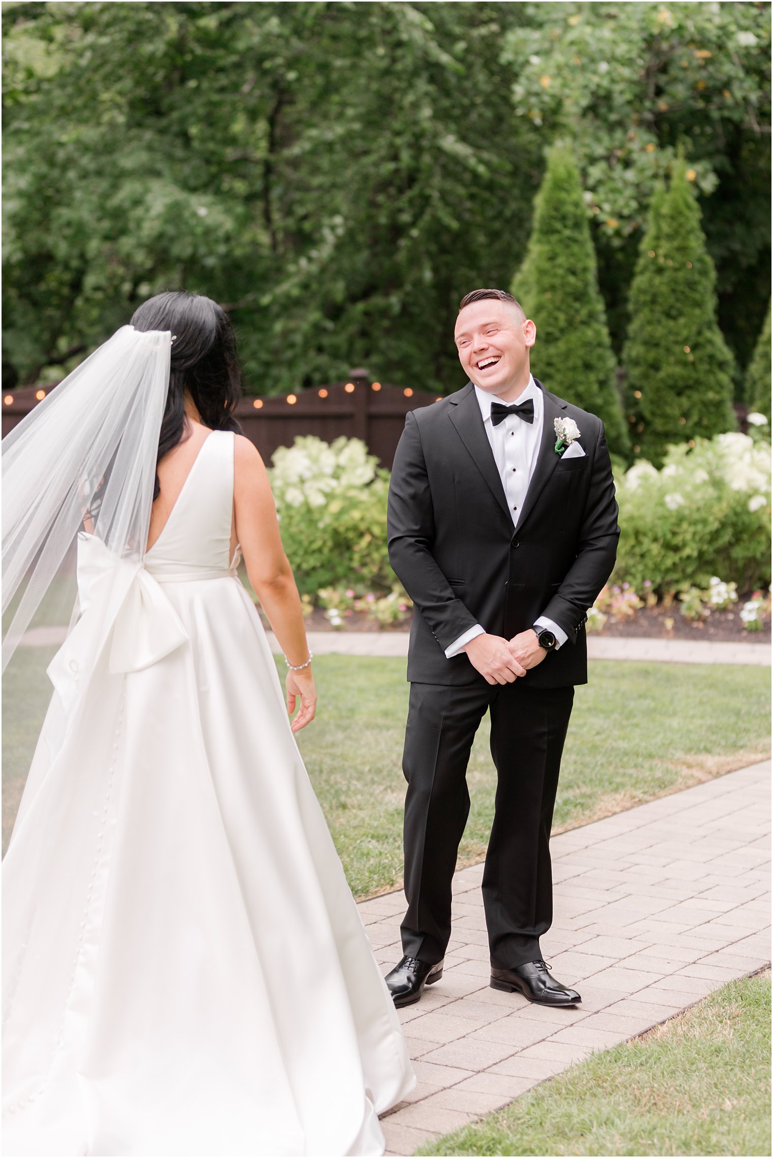 groom smiles seeing bride during first look