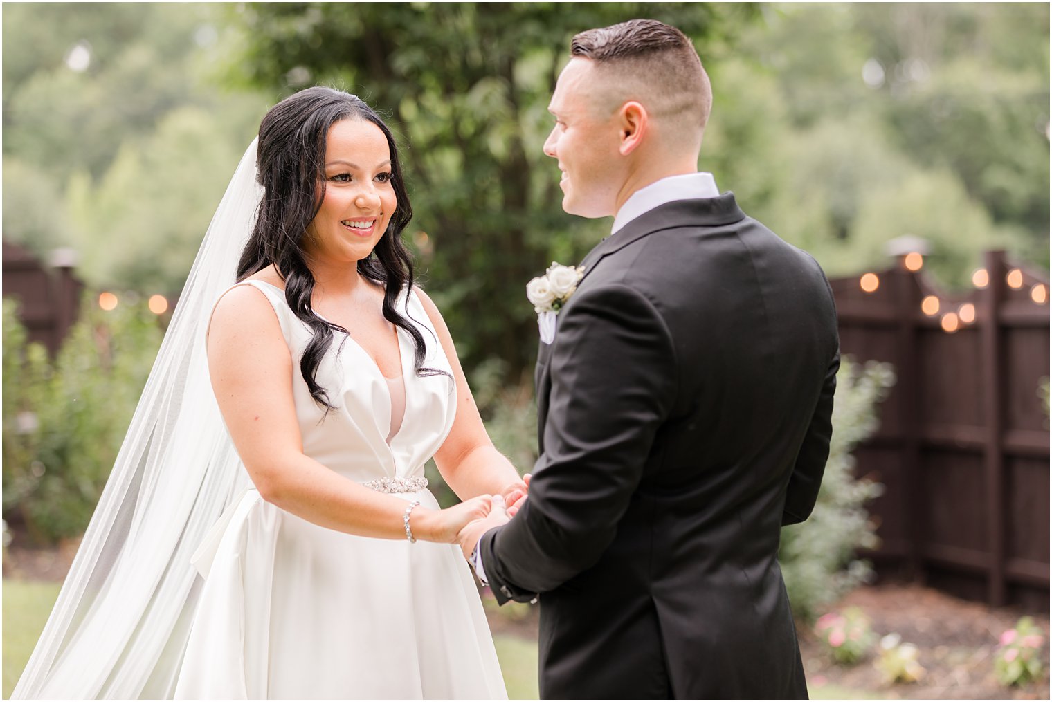 bride smiles at groom during first look at Hamilton Manor