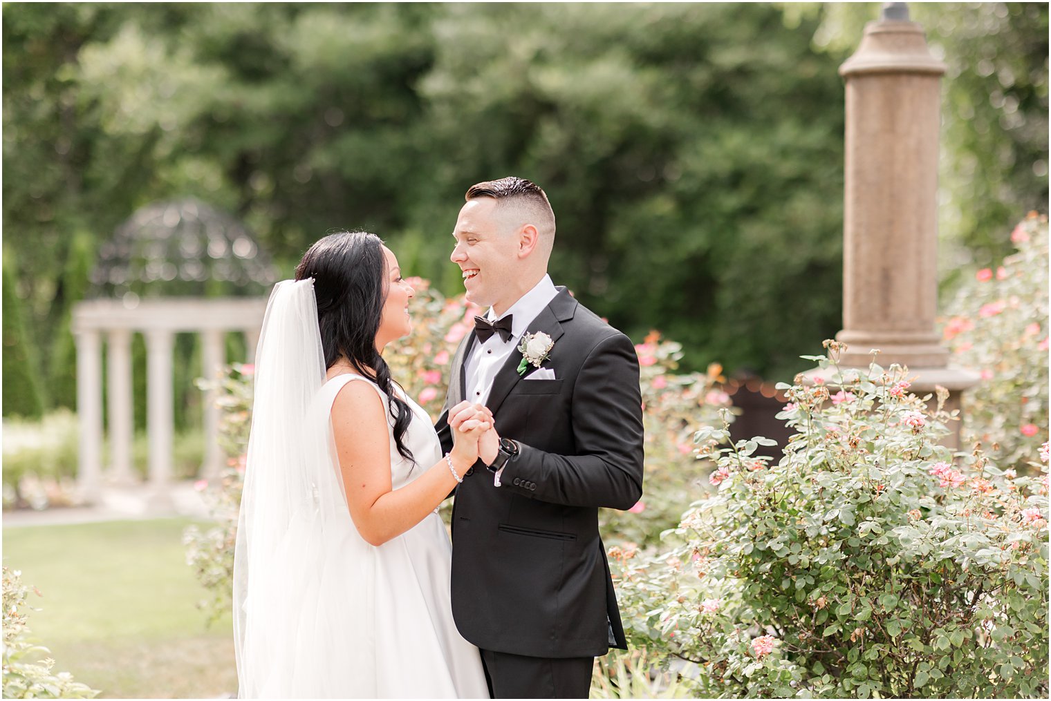 bride and groom laugh together in gardens at Hamilton Manor