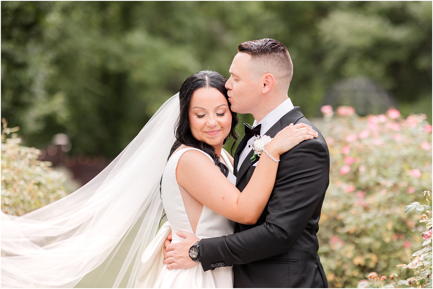 groom kisses bride's forehead during NJ wedding photos