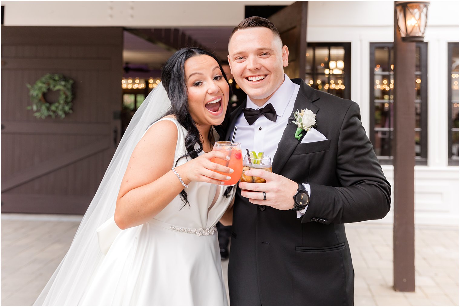 newlyweds toast signature cocktails during Hamilton Manor wedding reception 