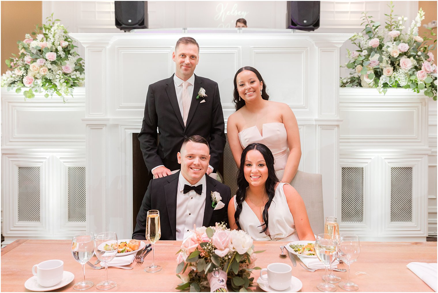 newlyweds sit with maid of honor and best man