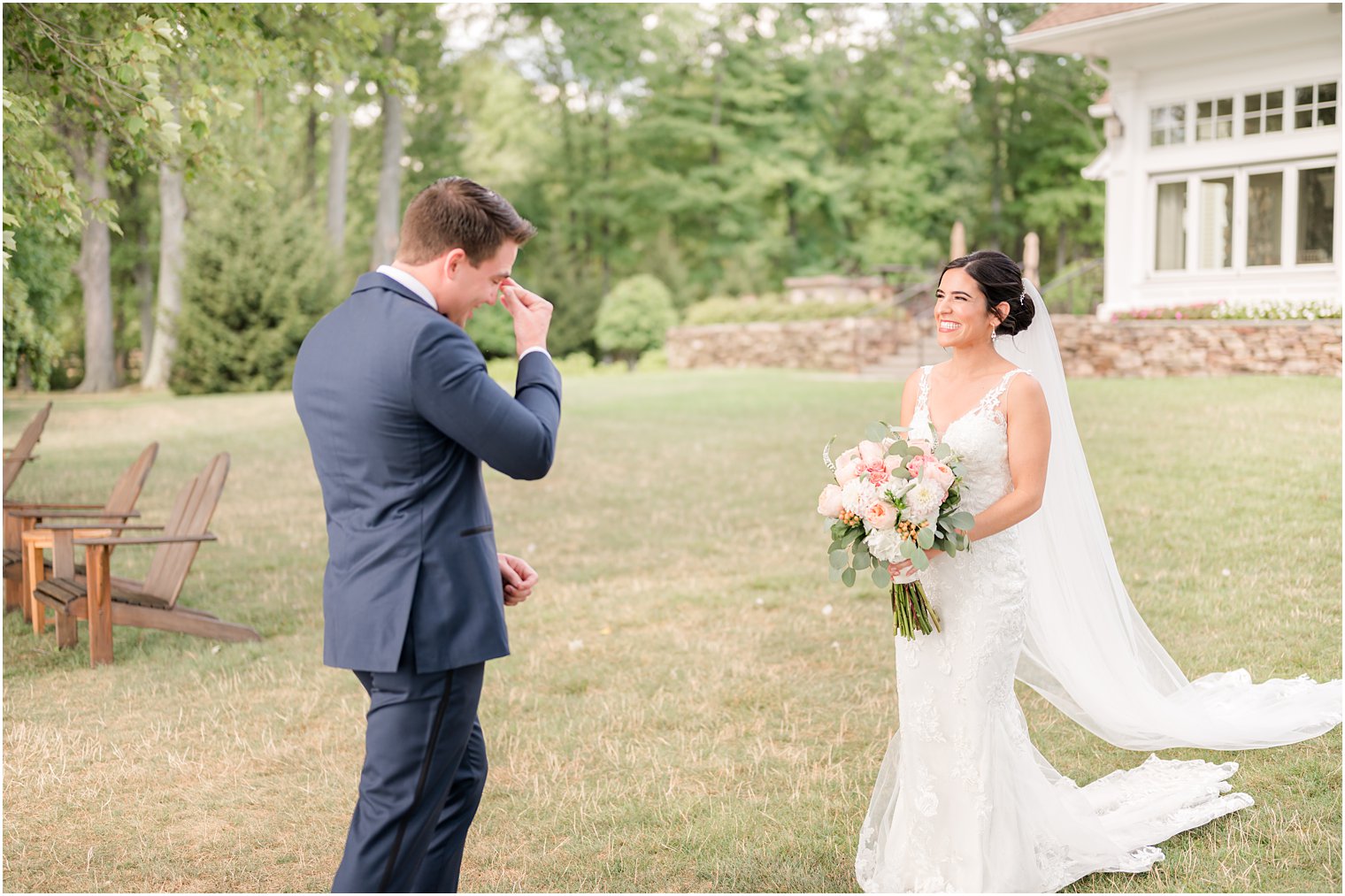 groom tries not to cry during first look