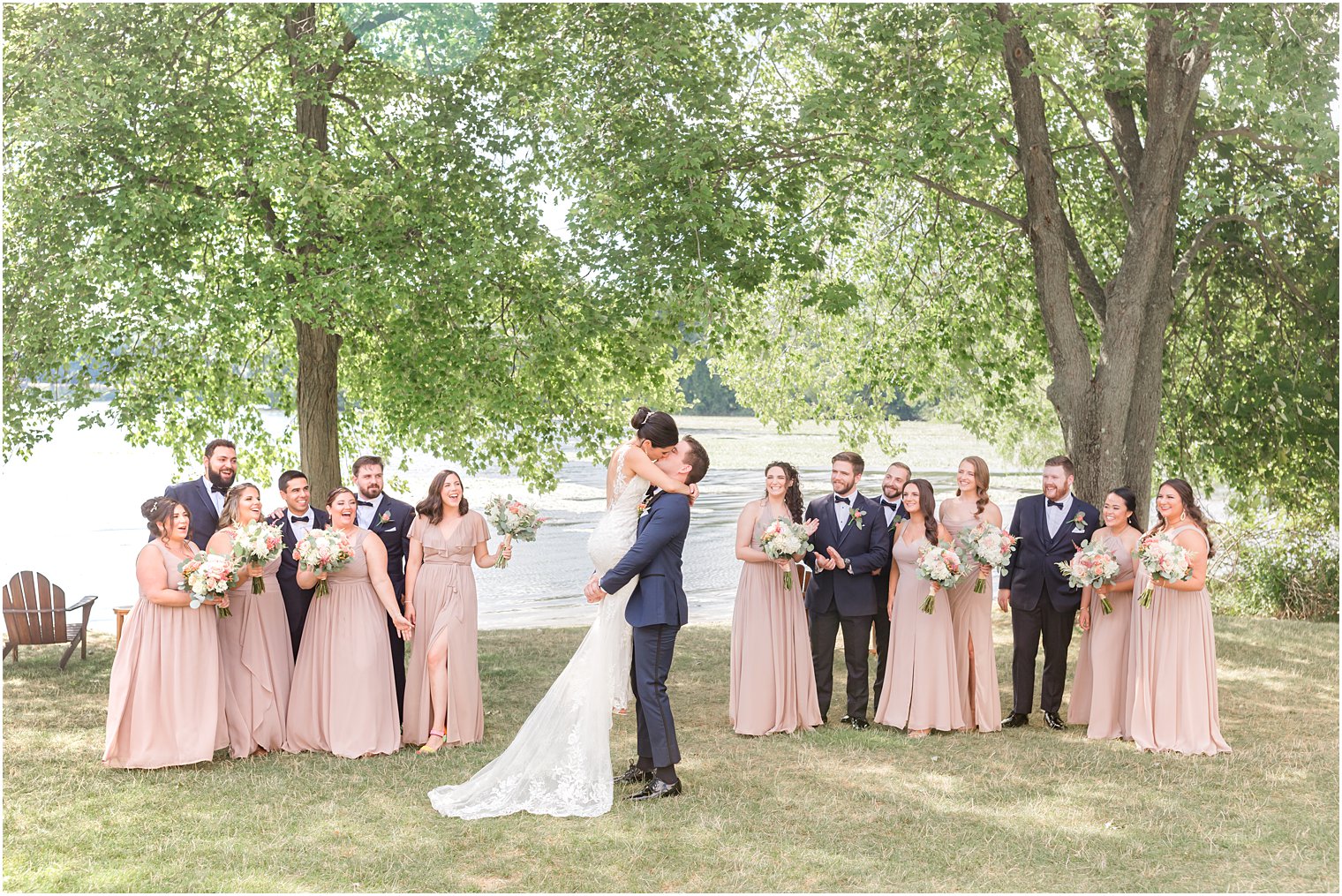 groom kisses bride lifting her up at Indian Trail Club