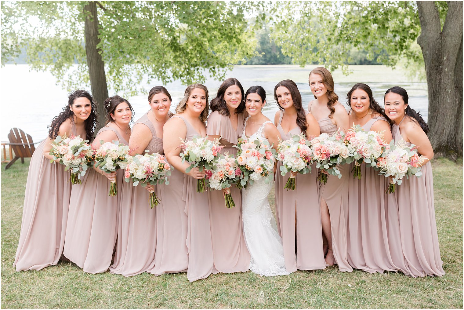bride hugs with bridesmaids in pink gowns