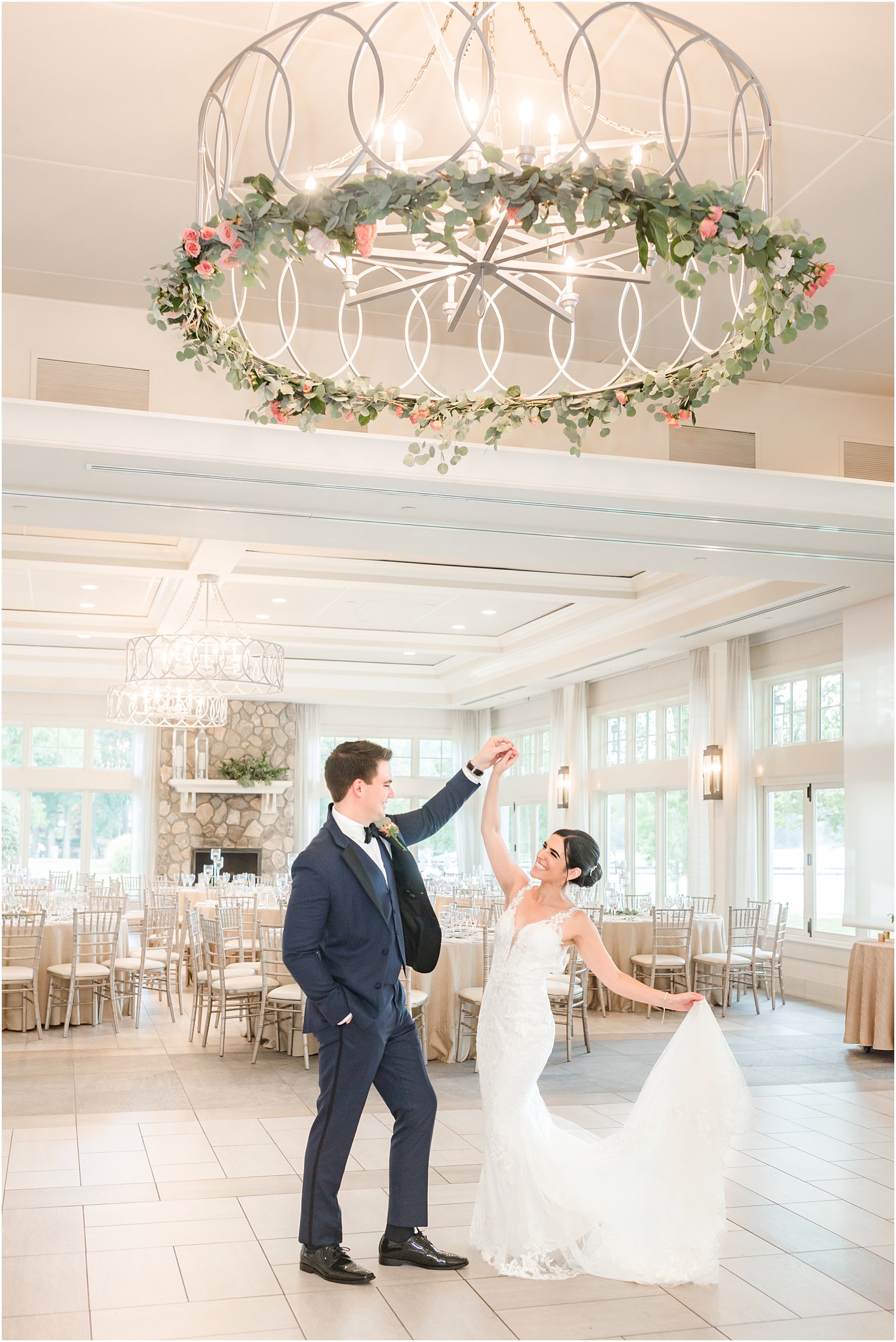 newlyweds dance under greenery chandelier at Indian Trail Club