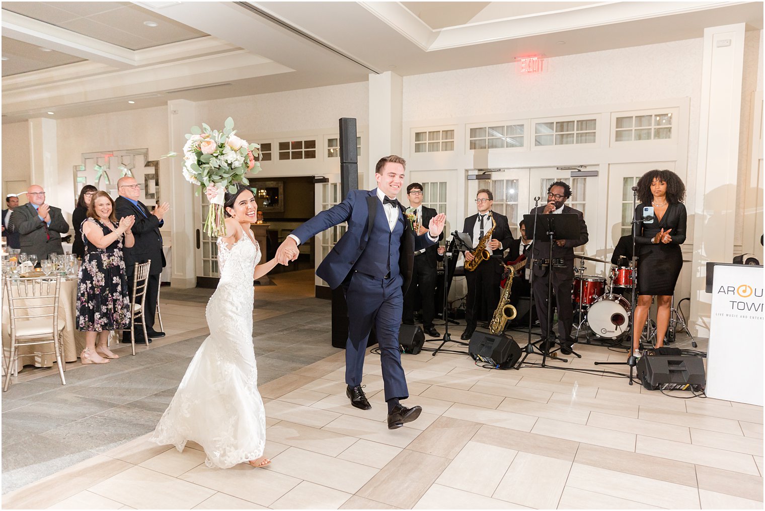 groom and bride walk onto dance floor at Indian Trail Club