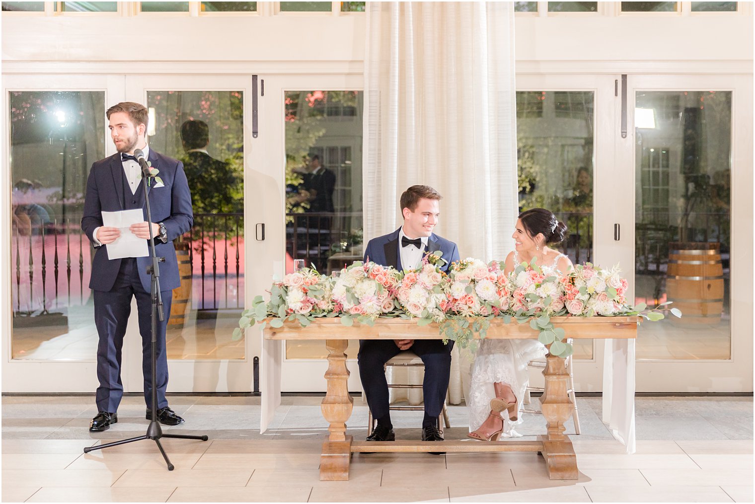 groomsman reads toast to bride and groom