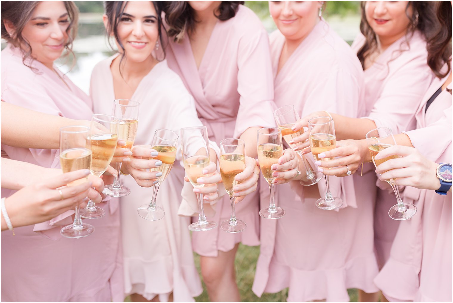 bridesmaids toast champagne with bride in pink robes