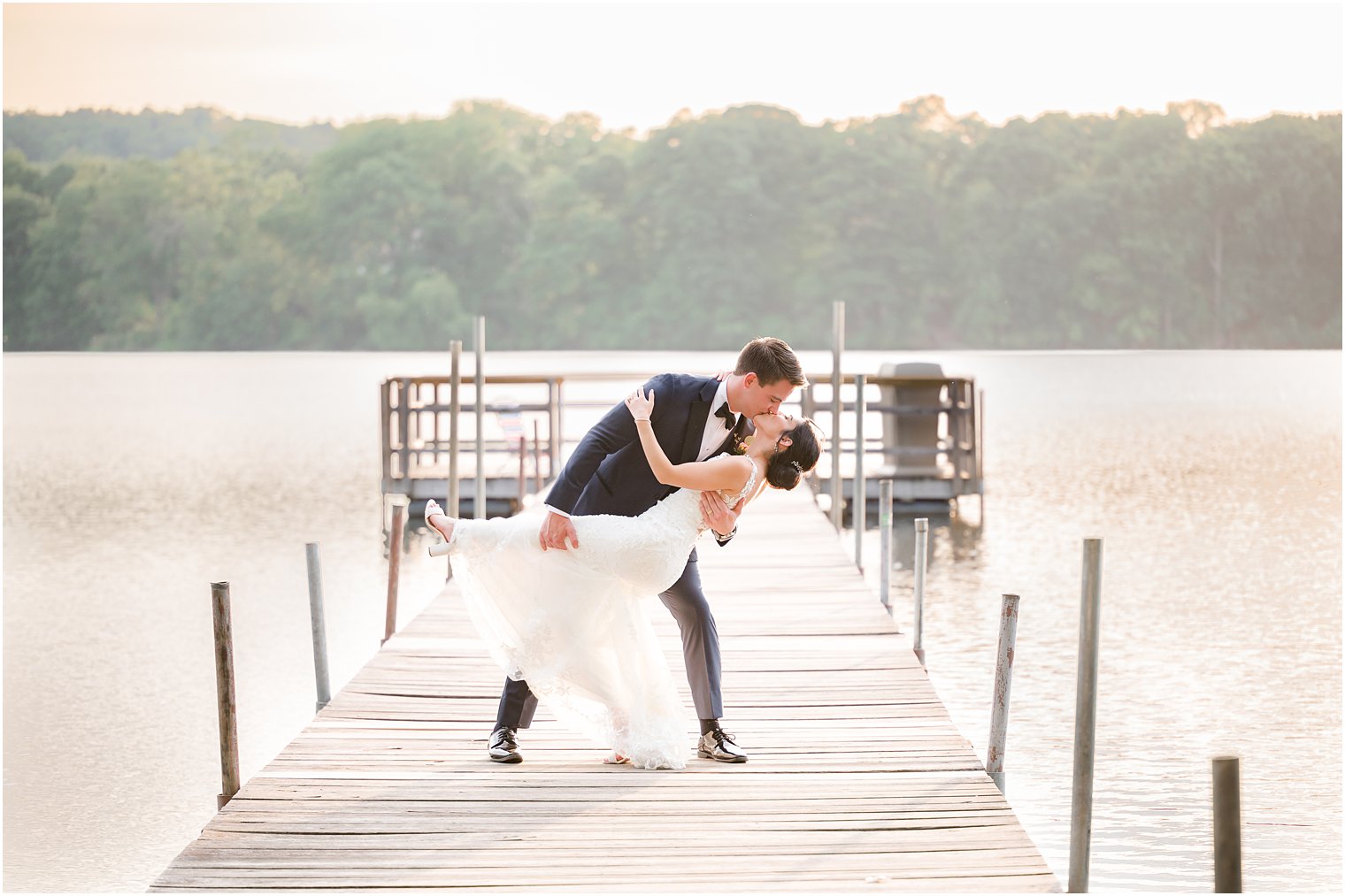 groom dips bride at sunset at Indian Trail Club