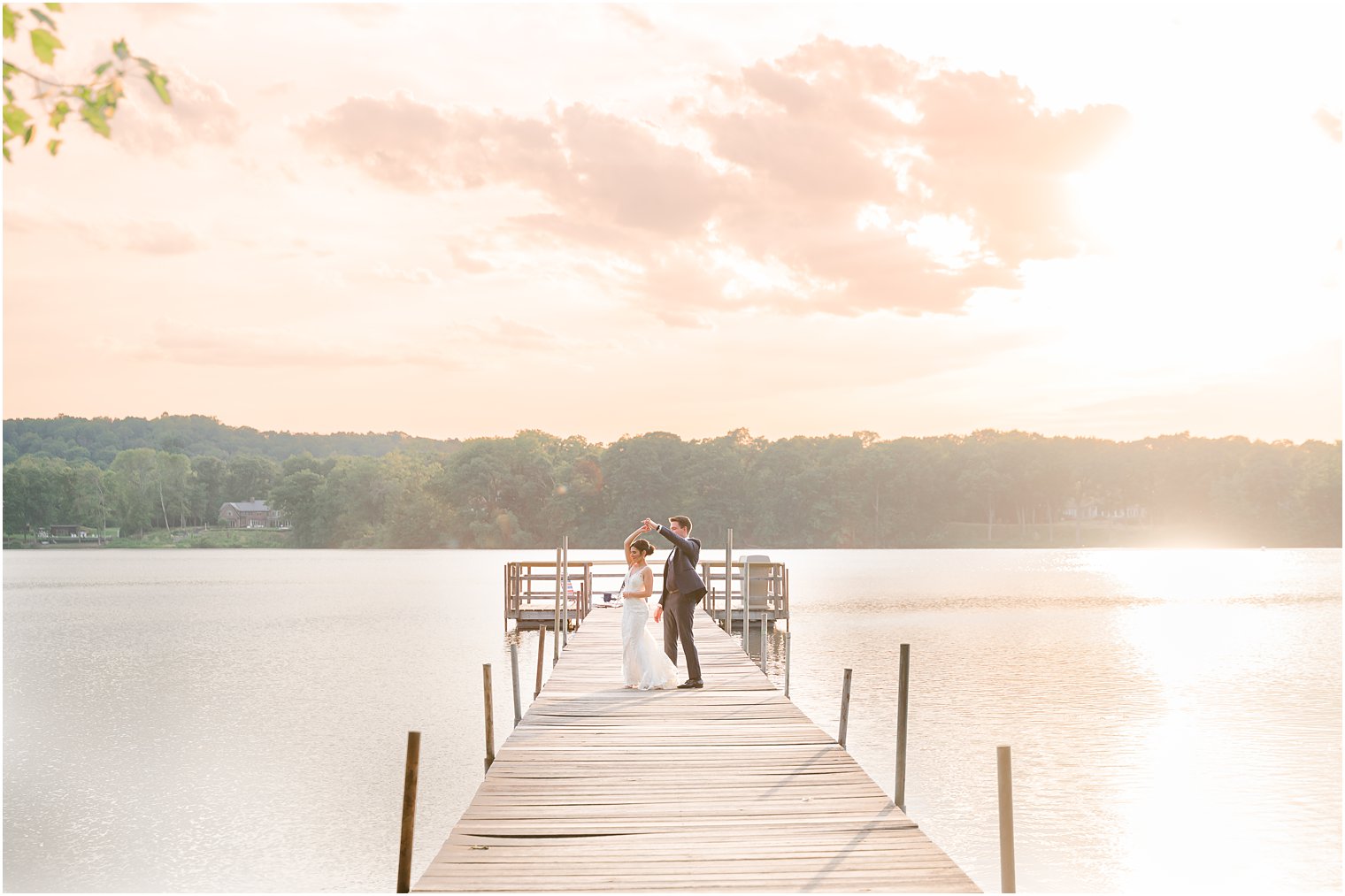 groom twirls bride at sunset at Indian Trail Club