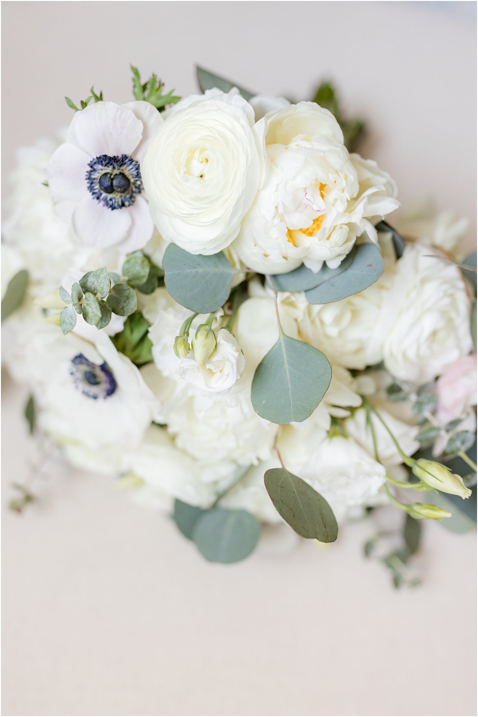 bride's bouquet with white flowers and green leaves 