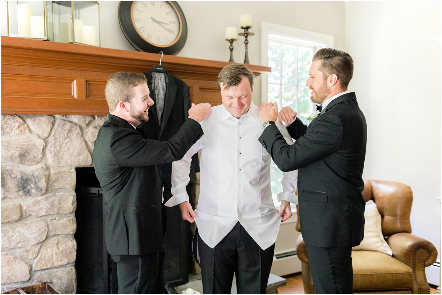 groomsmen help groom prepare for wedding 