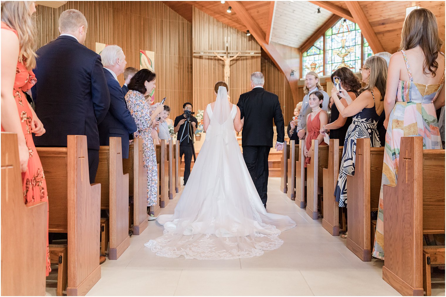 bride walks down aisle for traditional wedding ceremony at the Church of the Presentation