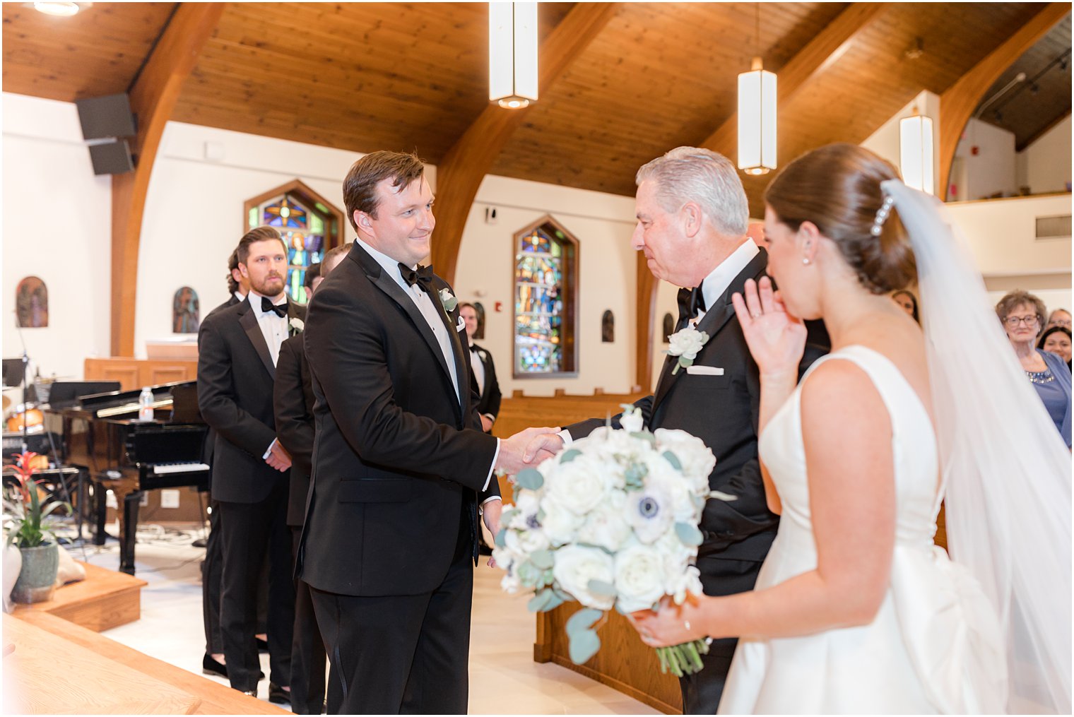 dad gives bride away during traditional wedding ceremony at the Church of the Presentation