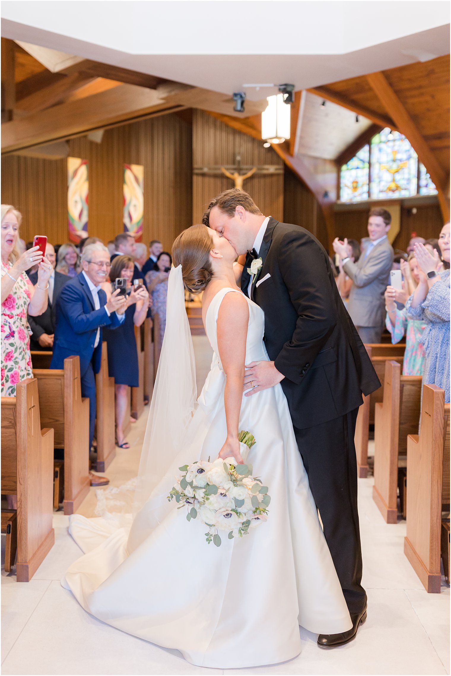 bride and groom kiss during traditional wedding ceremony at the Church of the Presentation