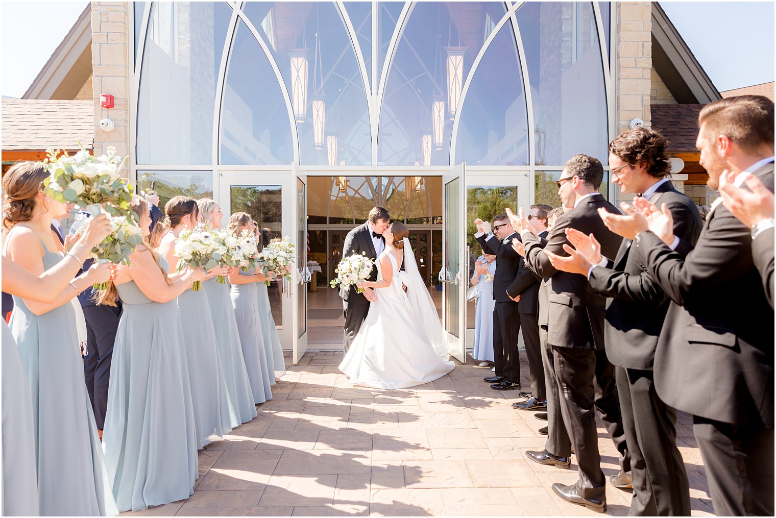 groom kisses bride outside the Church of the Presentation