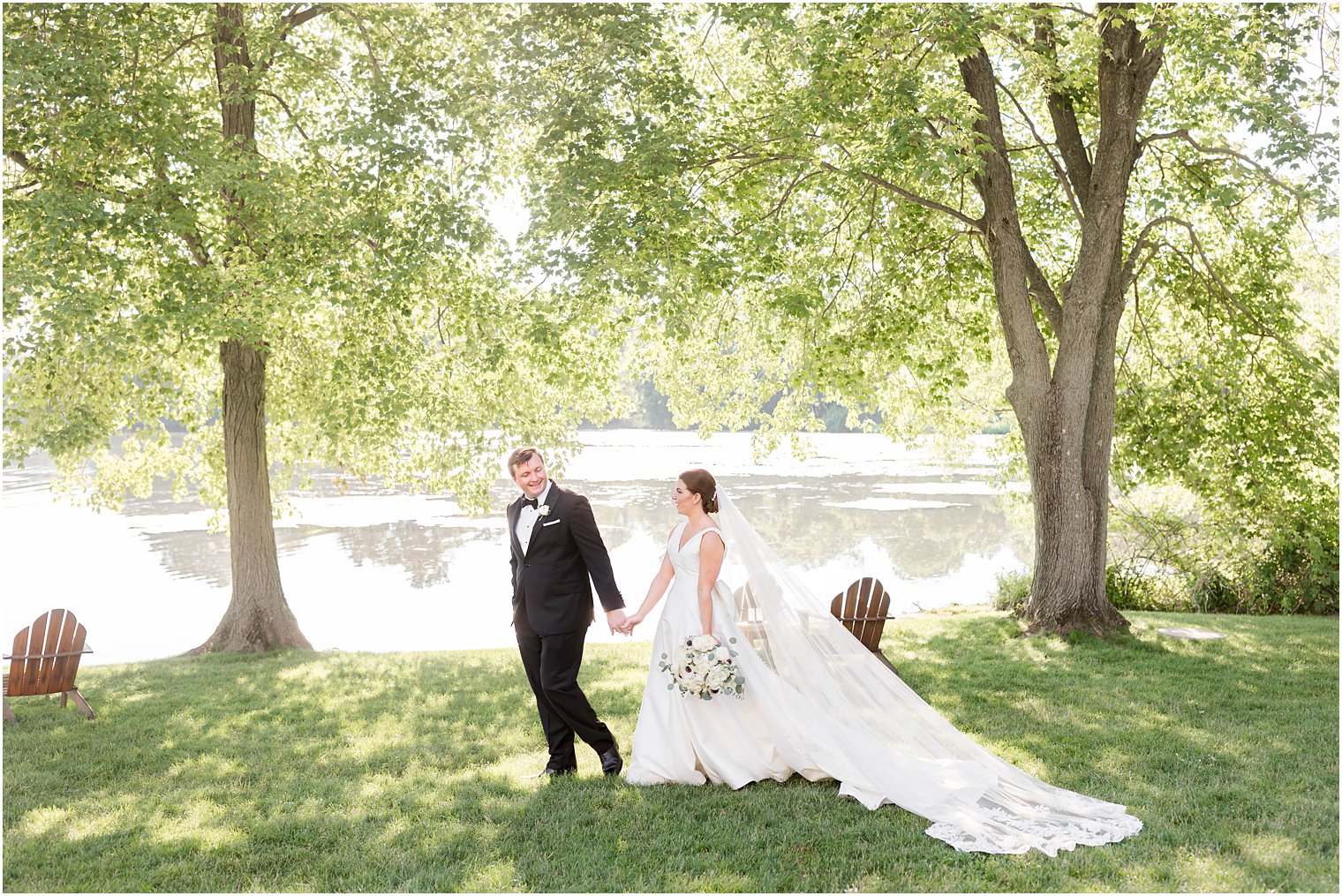 groom leads bride through trees at Indian Trail Club 