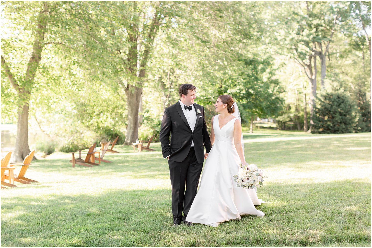 bride and groom walk together during wedding portraits at Indian Trail Club