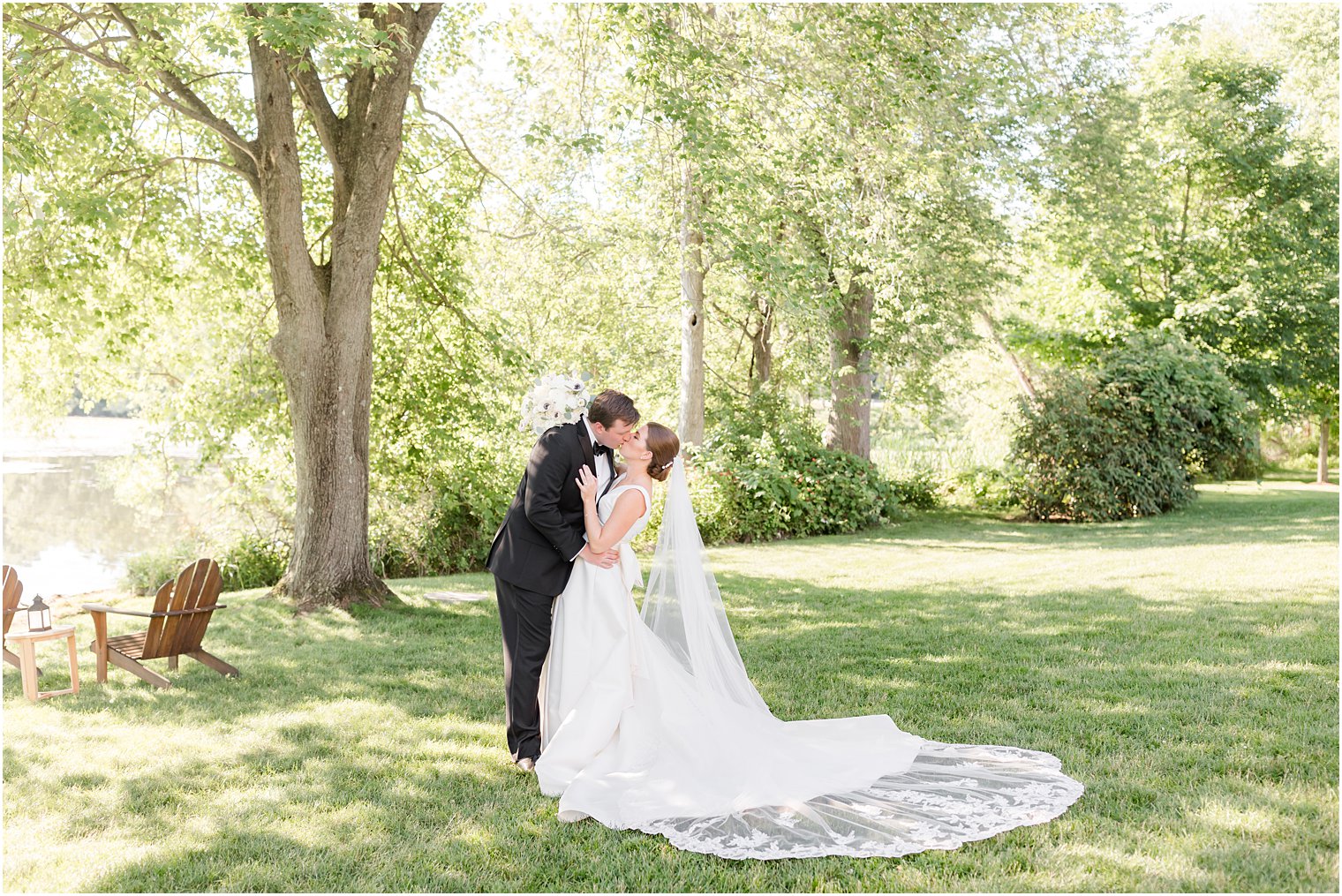 bride and groom kiss during Indian Trail Club wedding portraits 