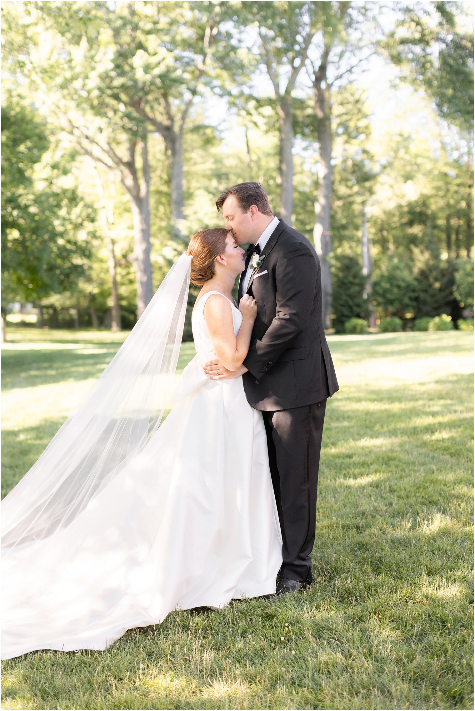 groom kisses bride's forehead at Indian Trail Club