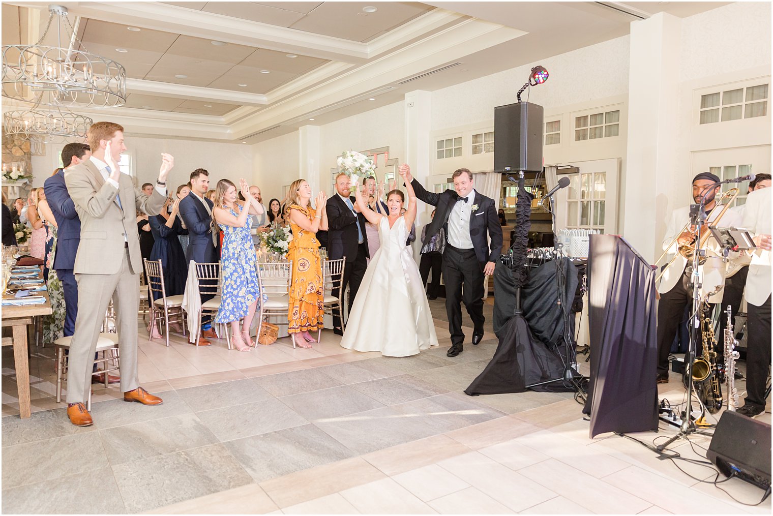 newlyweds cheer entering wedding reception