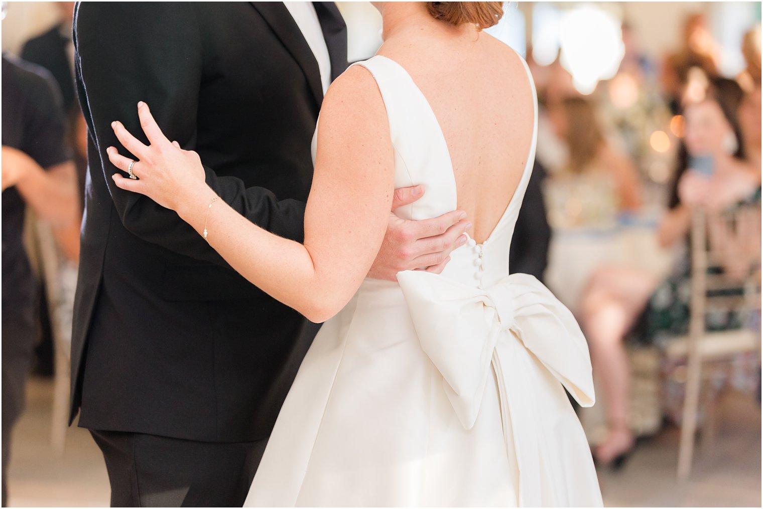 groom holds bride during first dance 