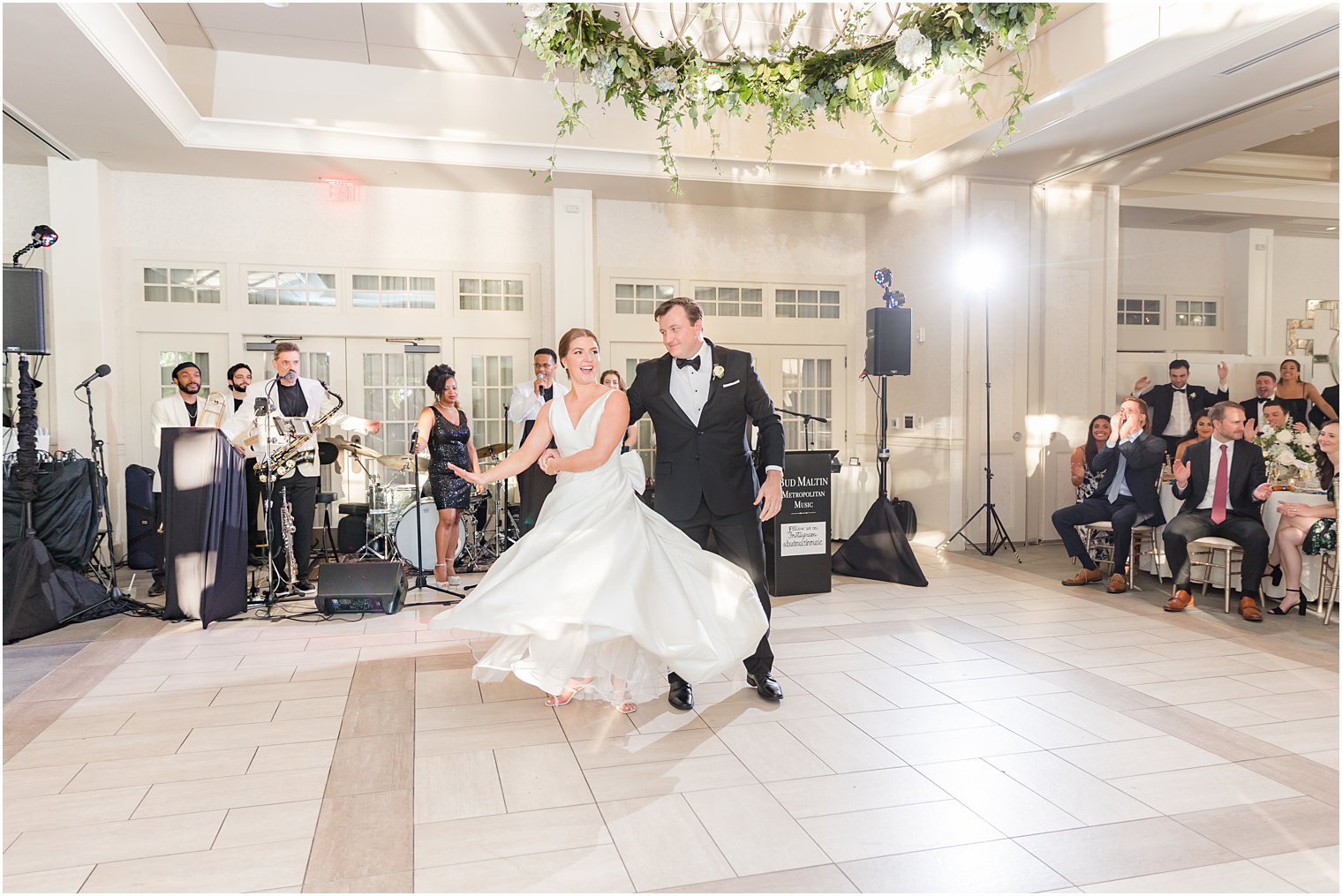 groom twirls bride on dance floor in New Jersey 