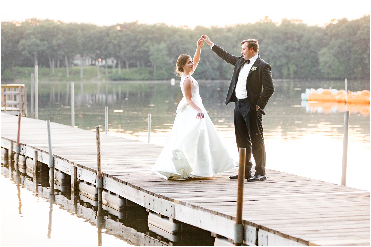 bride and groom twirl on dock at Indian Trail Club