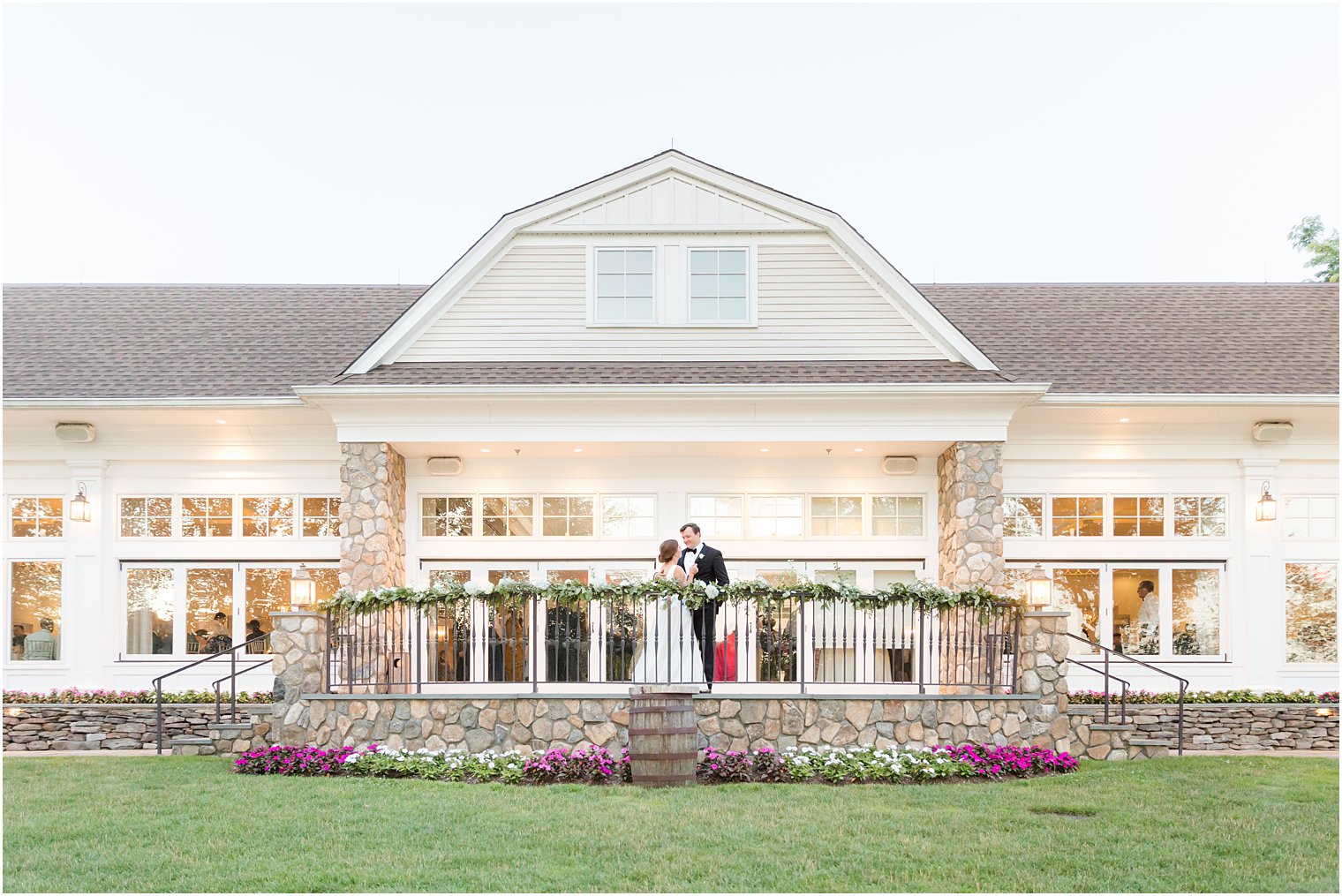 couple kisses on balcony at Indian Trail Club