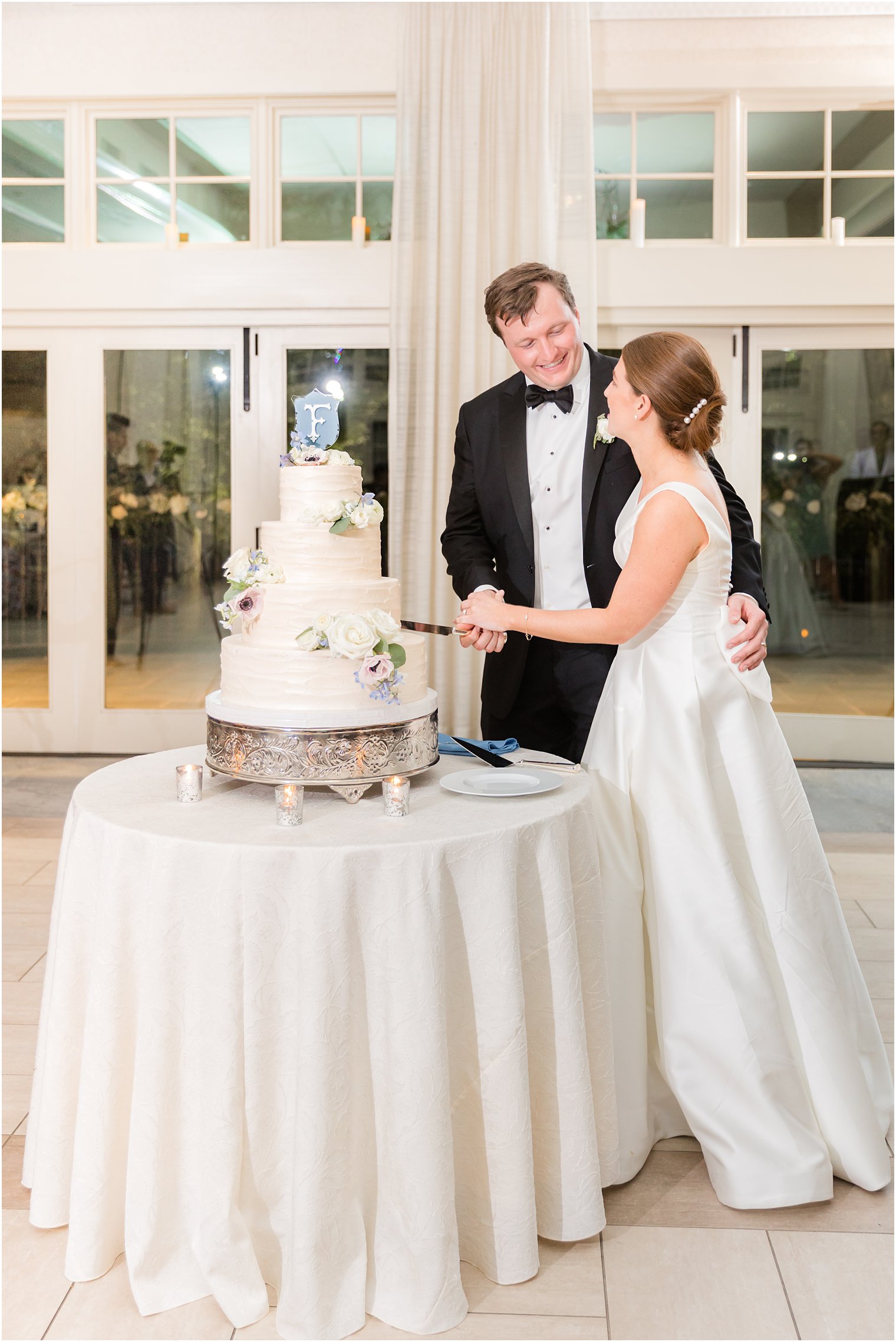 newlyweds cut wedding cake during NJ wedding reception