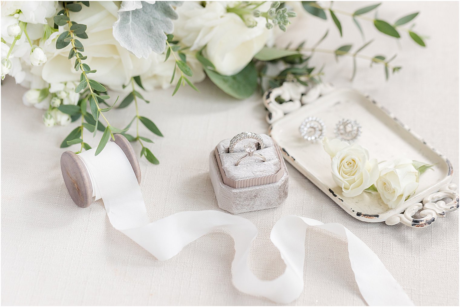 diamond ring in grey box with white ribbon