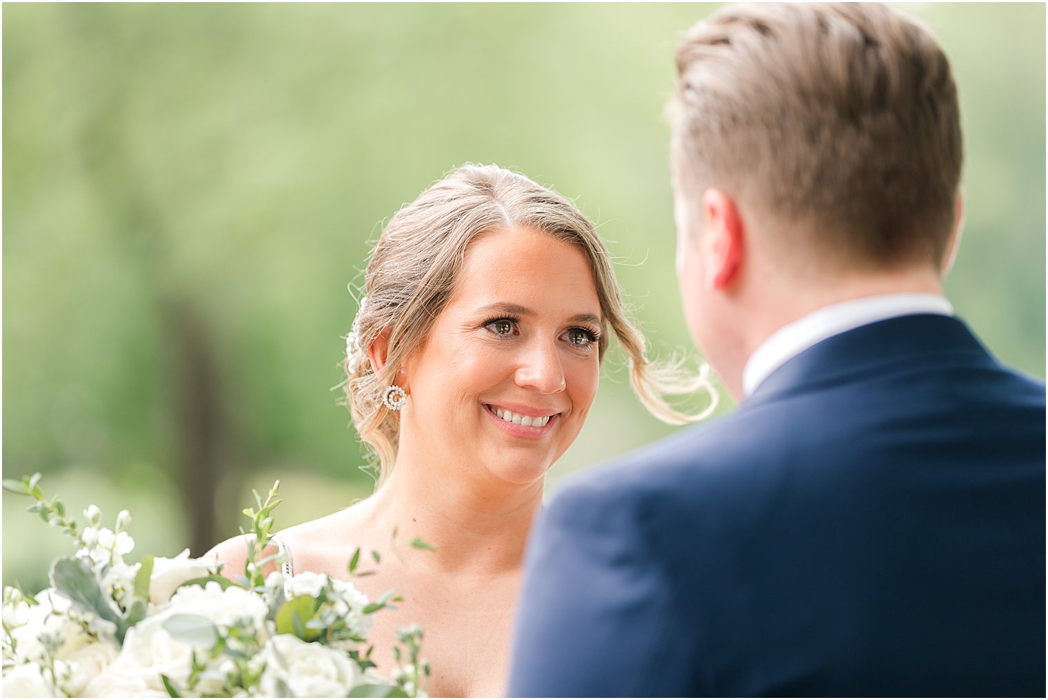 bride smiles up at groom during first look at Indian Trail Club