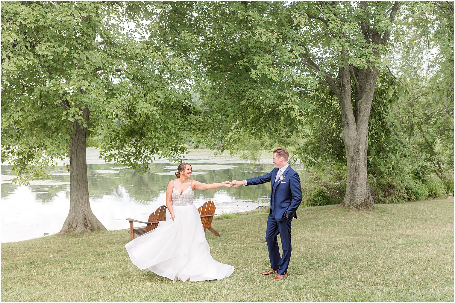 bride and groom walk by waterfront at Indian Trail Club
