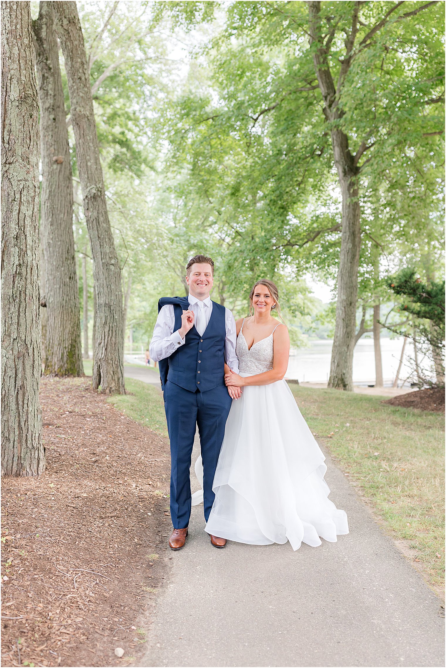 bride and groom walk on path at Indian Trail Club