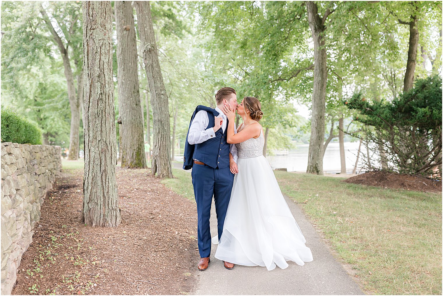 newlyweds kiss on path at Indian Trail Club