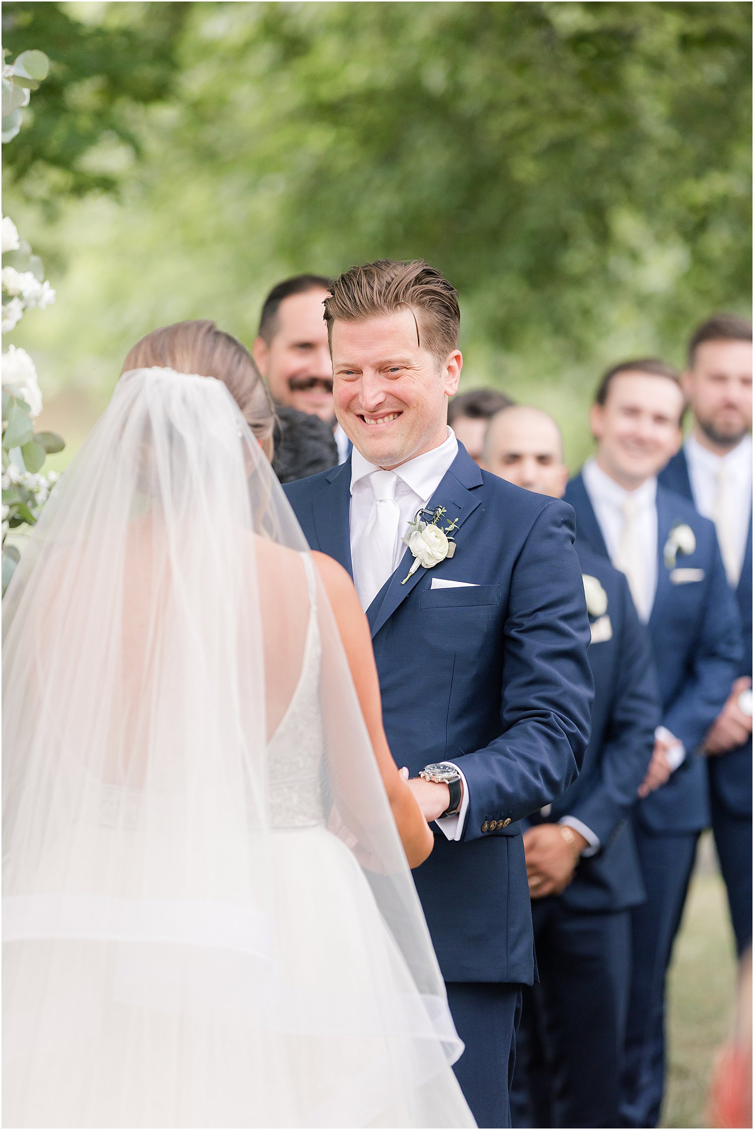 bride and groom exchange vows during outdoor wedding ceremony by water at Indian Trail Club